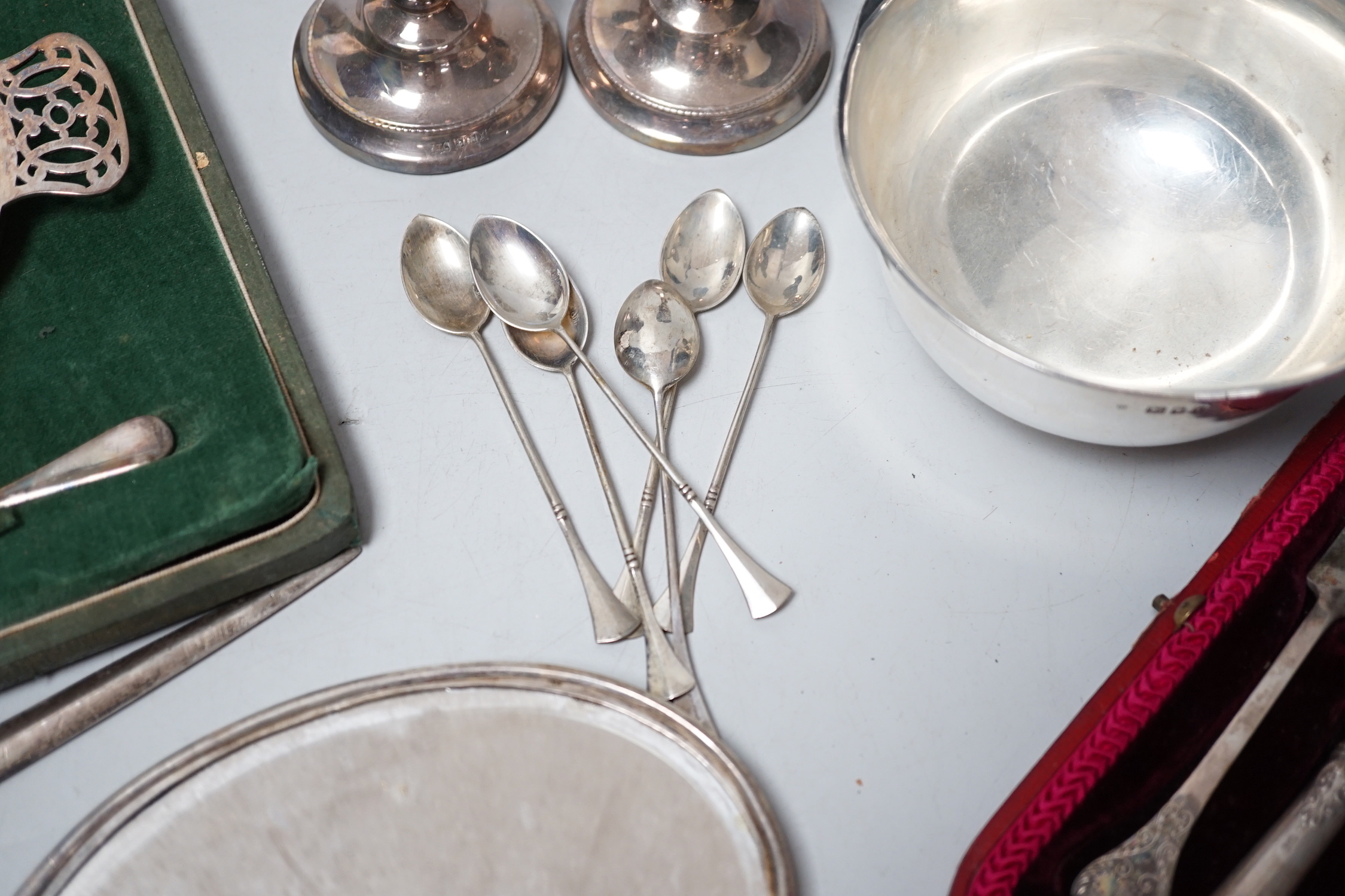 A George IV silver meat skewer, Robert Poulden, London, 1821, 30cm and other sundry silver including a George V bowl, a cased christening trio, pair of dwarf candlesticks, cased butter dish and knife, hand mirror etc.